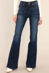 Front view of these jeans that feature a high rise high waist, five pocket detailing, belt loops, a zipper button front closure, and a flared bottom leg.
