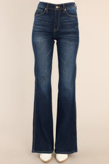 Front view of these jeans that feature a high rise high waist, three pocket detailing on the front, belt loops, a zipper button front closure, and a flared bottom leg.