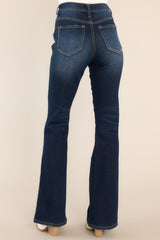 Back view of these jeans that feature a high rise high waist, five pocket detailing, belt loops, a zipper button front closure, and a flared bottom leg.