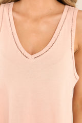 Close up view of this top that features a v-neckline, transparent detailing, and a soft & lightweight material. 