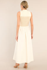 Back view of this dress that features a high neckline, a striped sweater bodice, and a flowy skirt.