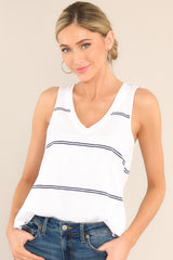 This blue and white top features a v-neckline, a scoop bottom hem, raw hemmed edges, and a light, breathable fabric. 