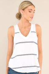 Front view of this top that features a v-neckline, a scoop bottom hem, raw hemmed edges, and a light, breathable fabric.