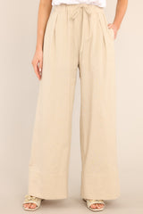 Front view of these pants that feature a high waisted design, an elastic waistband with a self-tie feature, functional pockets, and a thick ankle cuff. 