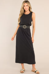 This black dress features a crew neckline, a straight silhouette, and a slightly stretchy cotton material that gives it a relaxed fit. Belt is not included. 