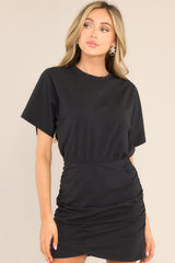 Full front view of this dress that features a crew neckline, an elastic waistband, ruching down the sides, and wide sleeves.