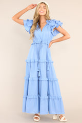 Full body view of this dress that features a v-neckline with a self-tie closure, ruffled flutter sleeves, a drawstring waistband, and a long, flowy skirt.