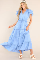 Front view of this dress that features a v-neckline with a self-tie closure, ruffled flutter sleeves, a drawstring waistband, and a long, flowy skirt.