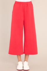 Front view of these pants that feature a high waisted design, an elastic waistband, functional hip pockets, a textured crisscross design, and a wide leg.