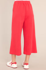 Back view of these pants that feature a high waisted design, an elastic waistband, functional hip pockets, a textured crisscross design, and a wide leg.