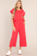 Full front view of these pants that feature a high waisted design, an elastic waistband, functional hip pockets, a textured crisscross design, and a wide leg.