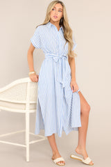 Front view of this dress that features a collared neckline, a full button front, a fitted waist, a self-tie waist belt, functional pockets, two side slits, and folded short sleeves.