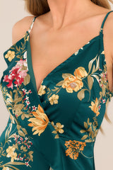 Close up of the v-neckline and ruffled detailing on the bust of this emerald floral wrap midi dress.