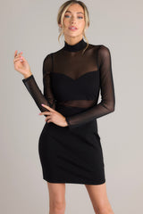 Front view of this dress that features a high neckline, a discrete zipper down the back, meshing in the chest, back, & waist, a bodycon style fit, and fully meshed long sleeves.
