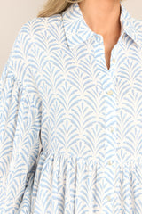 Detailed view of the dropped sleeves on this blue printed mini dress.