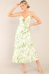 Front view of this green floral dress featuring adjustable straps. 