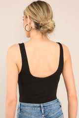 Back view of this bodysuit that features thick straps, double scoop necklines, and a thonged bottom.