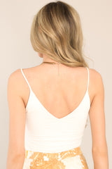 Back view of  this bodysuit that features a v-neckline, non-adjustable spaghetti straps, a low open back, and snap closure at the bottom.