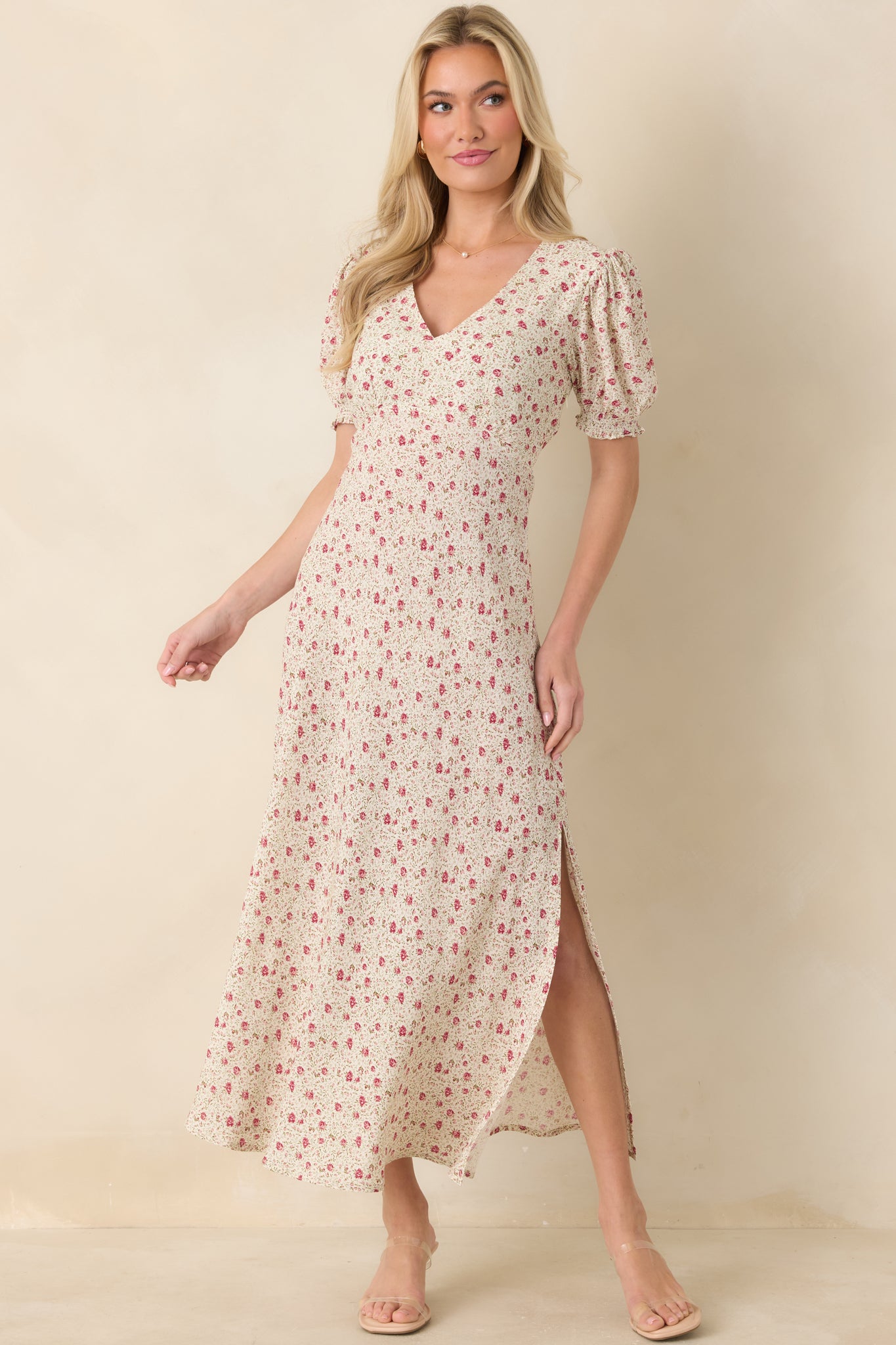 Woman wearing a floral dress with a plain background