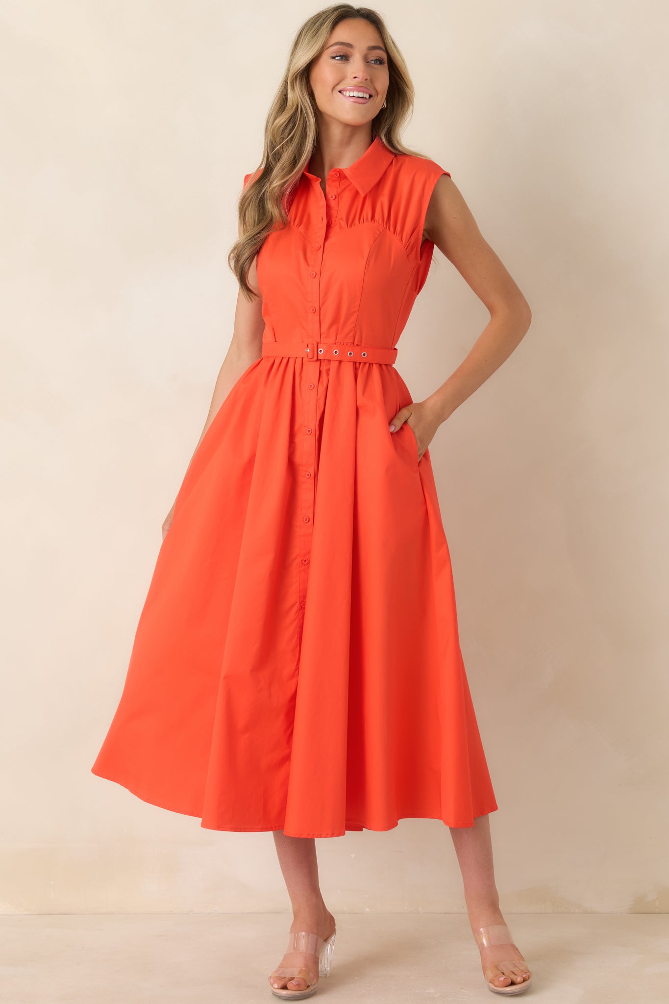 Structured cotton midi dress featuring classic collar, front buttons, and flowing midi skirt.