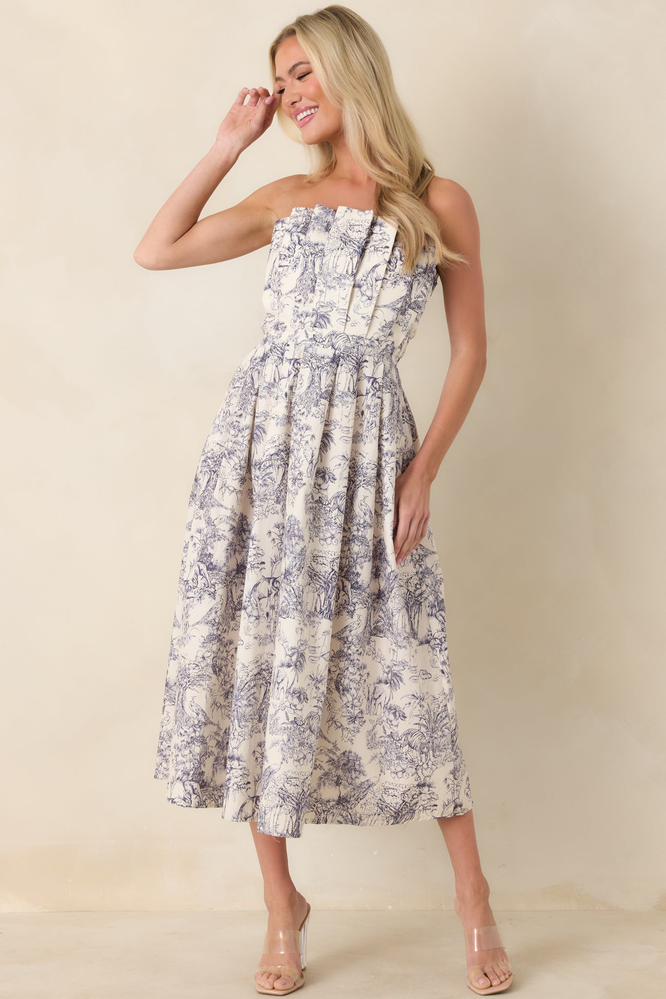 Strapless blue toile midi dress with pleated bodice and softly pleated skirt.