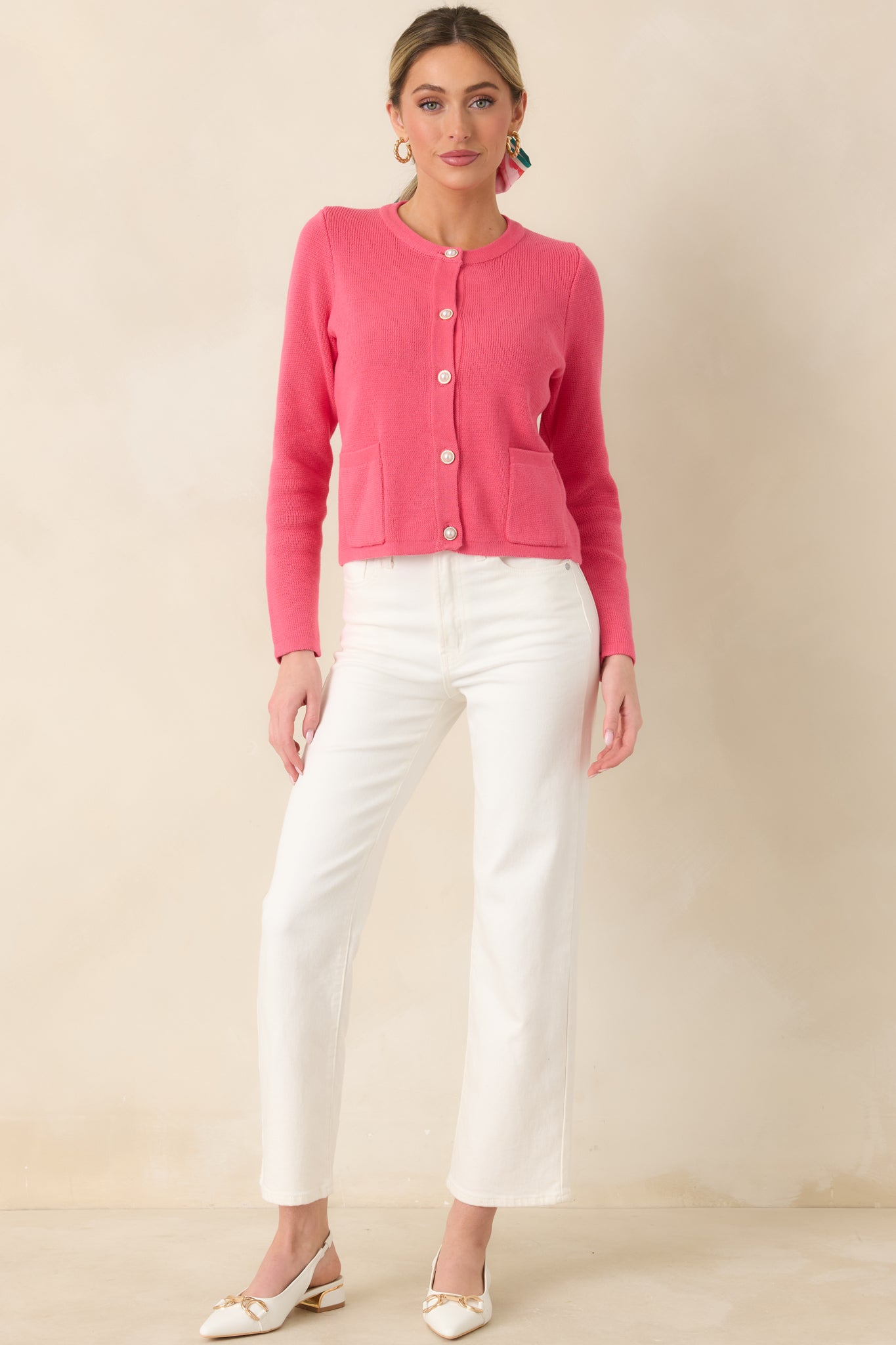 Cotton cardigan with a subtly textured knit, round neckline, pearl-inspired buttons down the front, and two classic patch pockets.