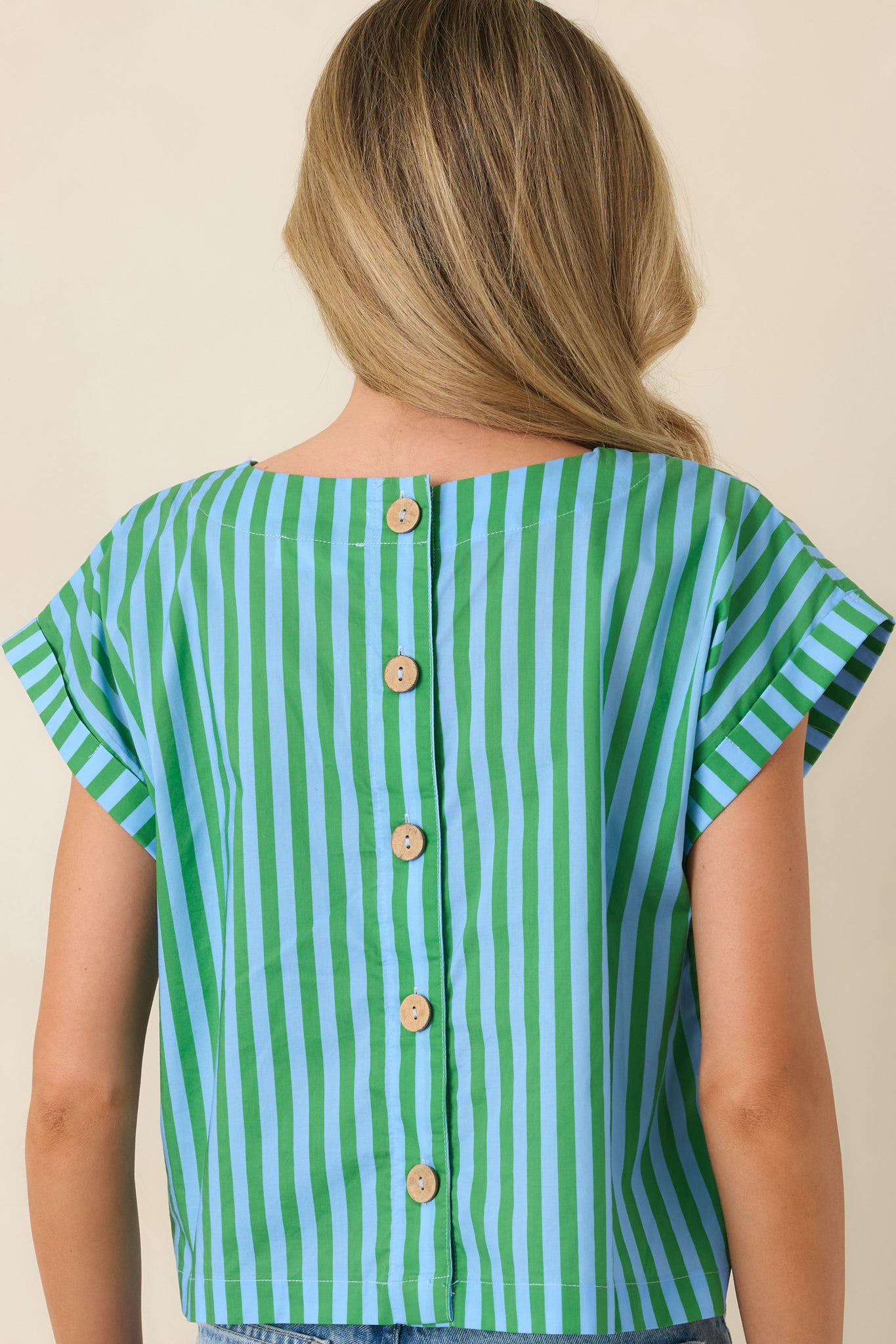 Back view of the boxy cotton top highlighting the functional back button closures and relaxed fit.