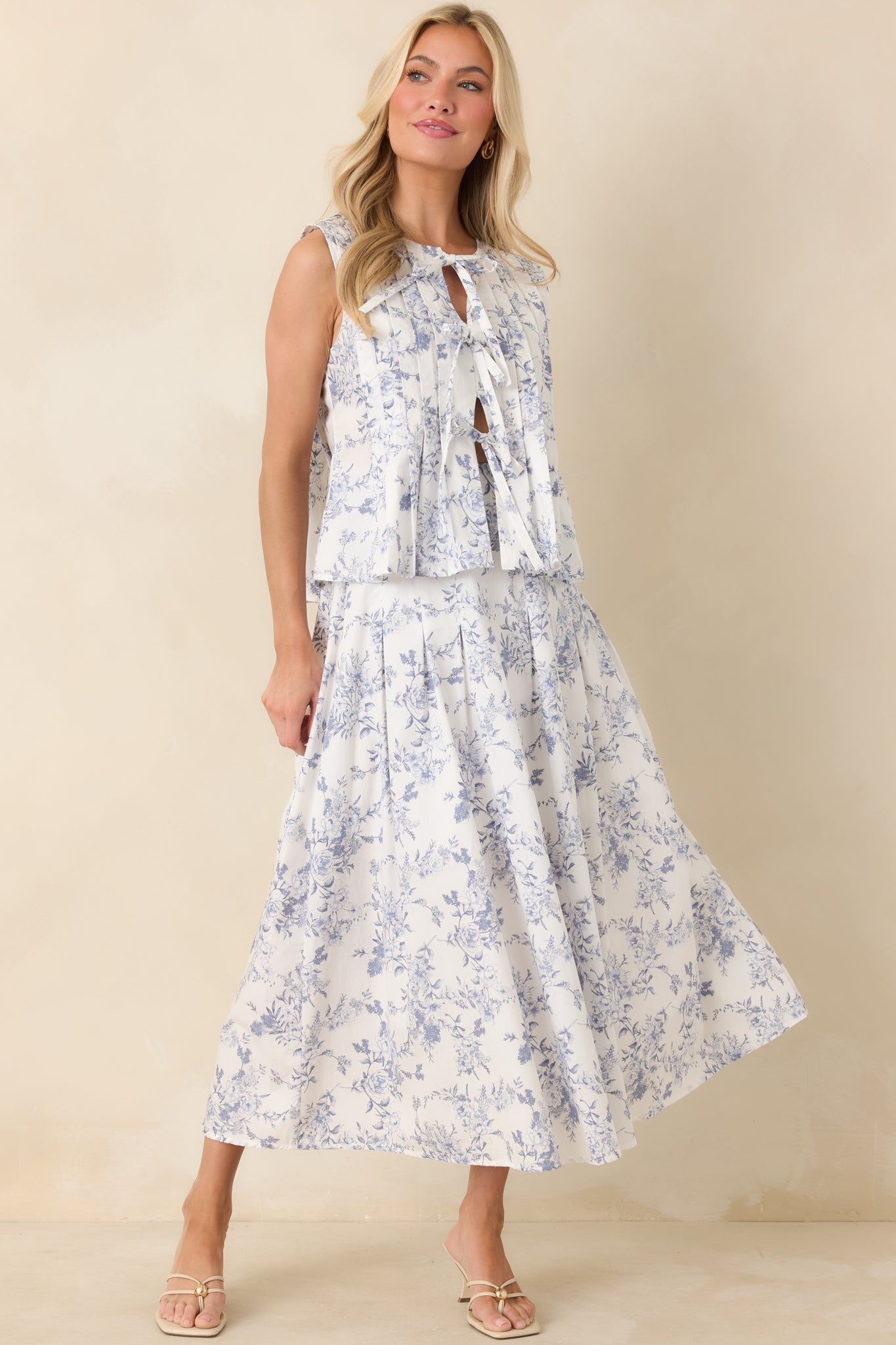 Cotton tie-front top featuring a whimsical blue floral toile pattern and soft, relaxed silhouette.
