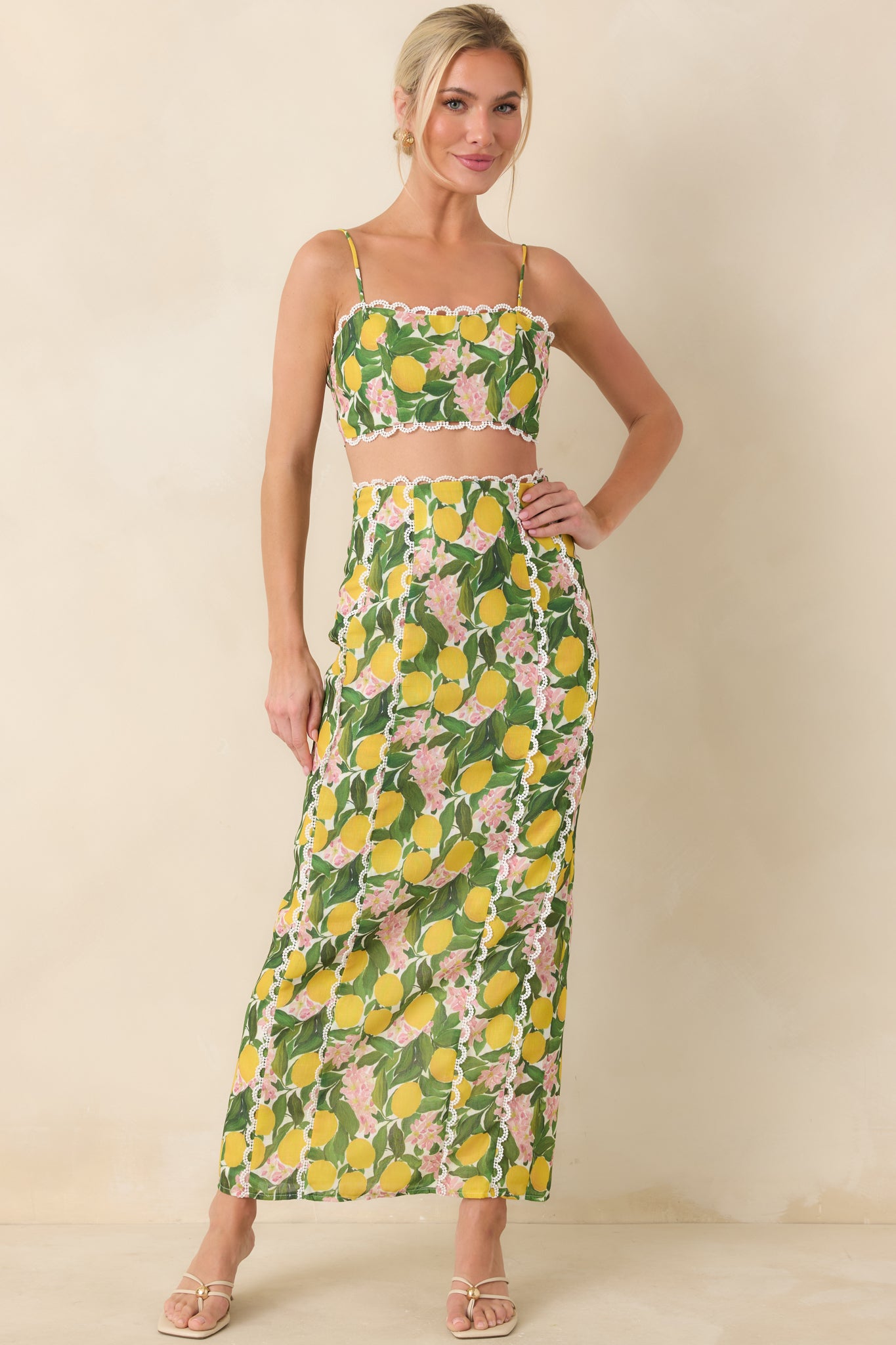 Structured cropped camisole in lemon blossom print with lace detailing along the neckline and a smooth, tailored shape.