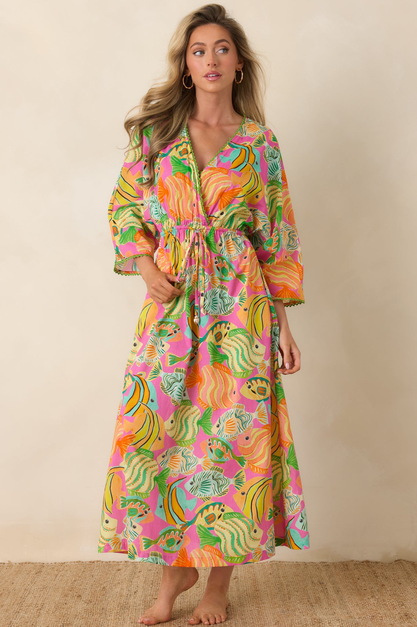 Cotton dress with billowy sleeves, flattering V-neckline, and lively resort-ready print.