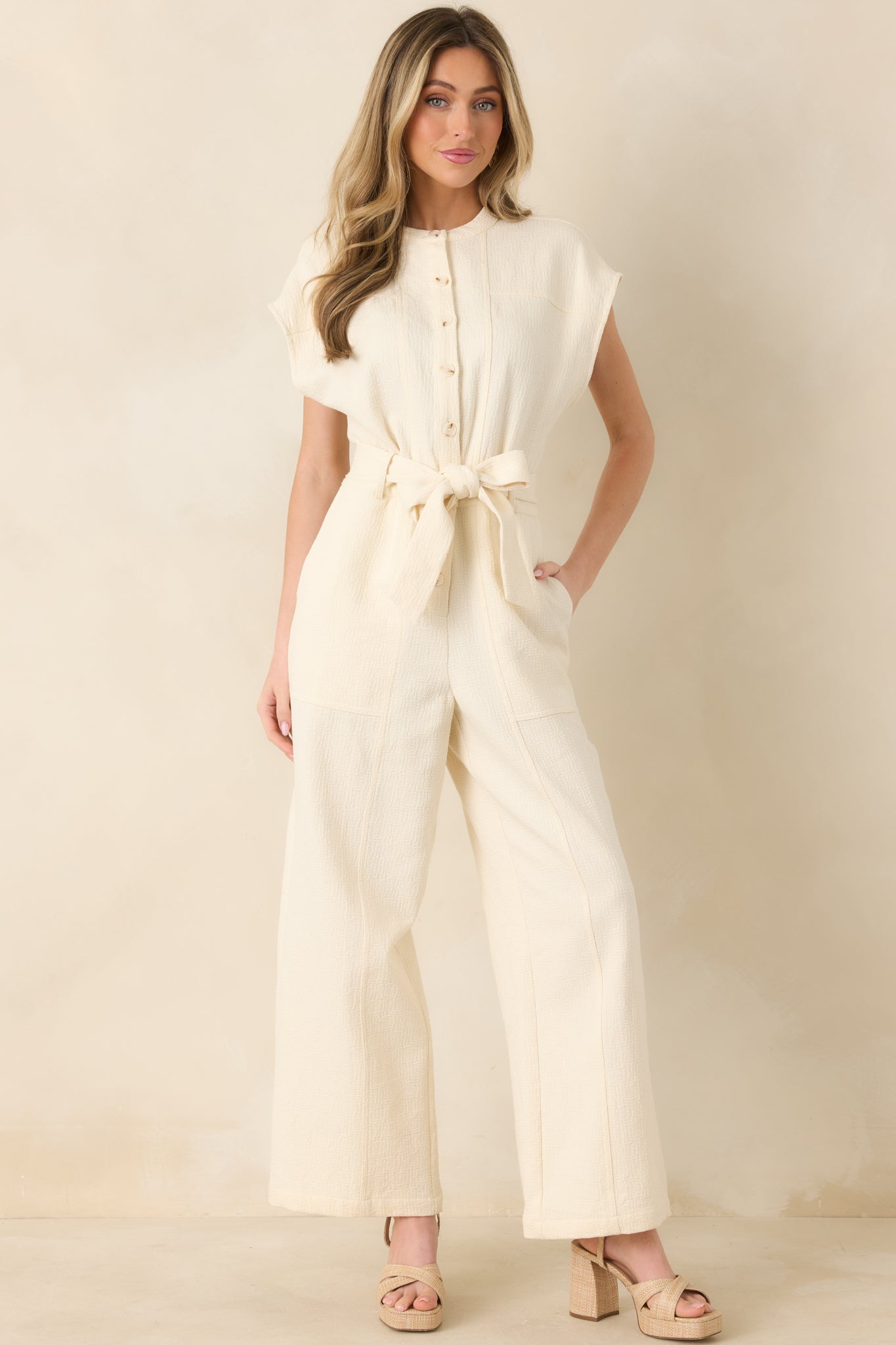 Front-facing view emphasizing button-front detailing, lightweight fabric, and flattering belt at the waist.