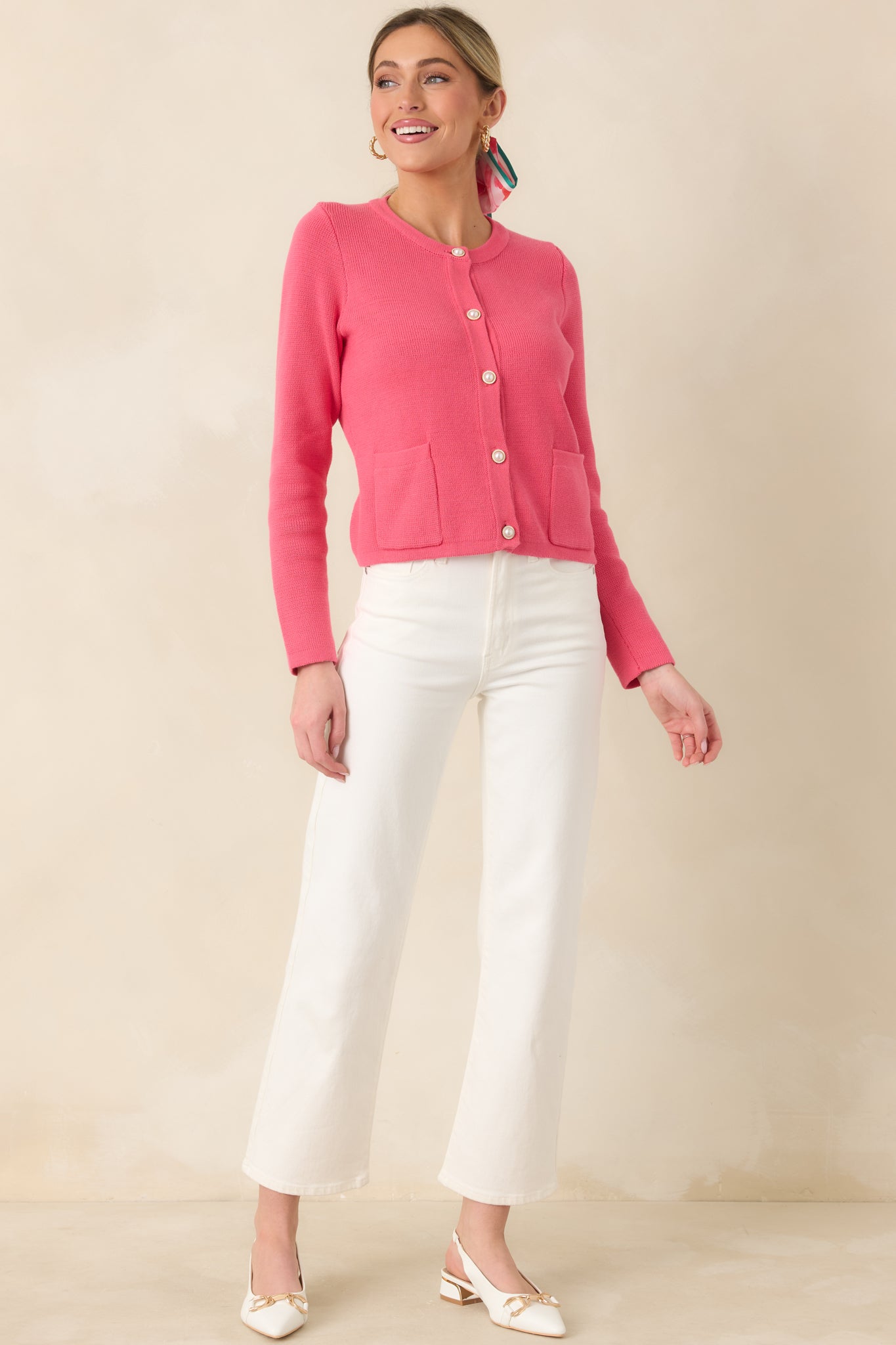 Soft cotton cardigan featuring a round neckline, delicate pearl-style buttons, textured knit fabric, and front patch pockets for a timeless look.