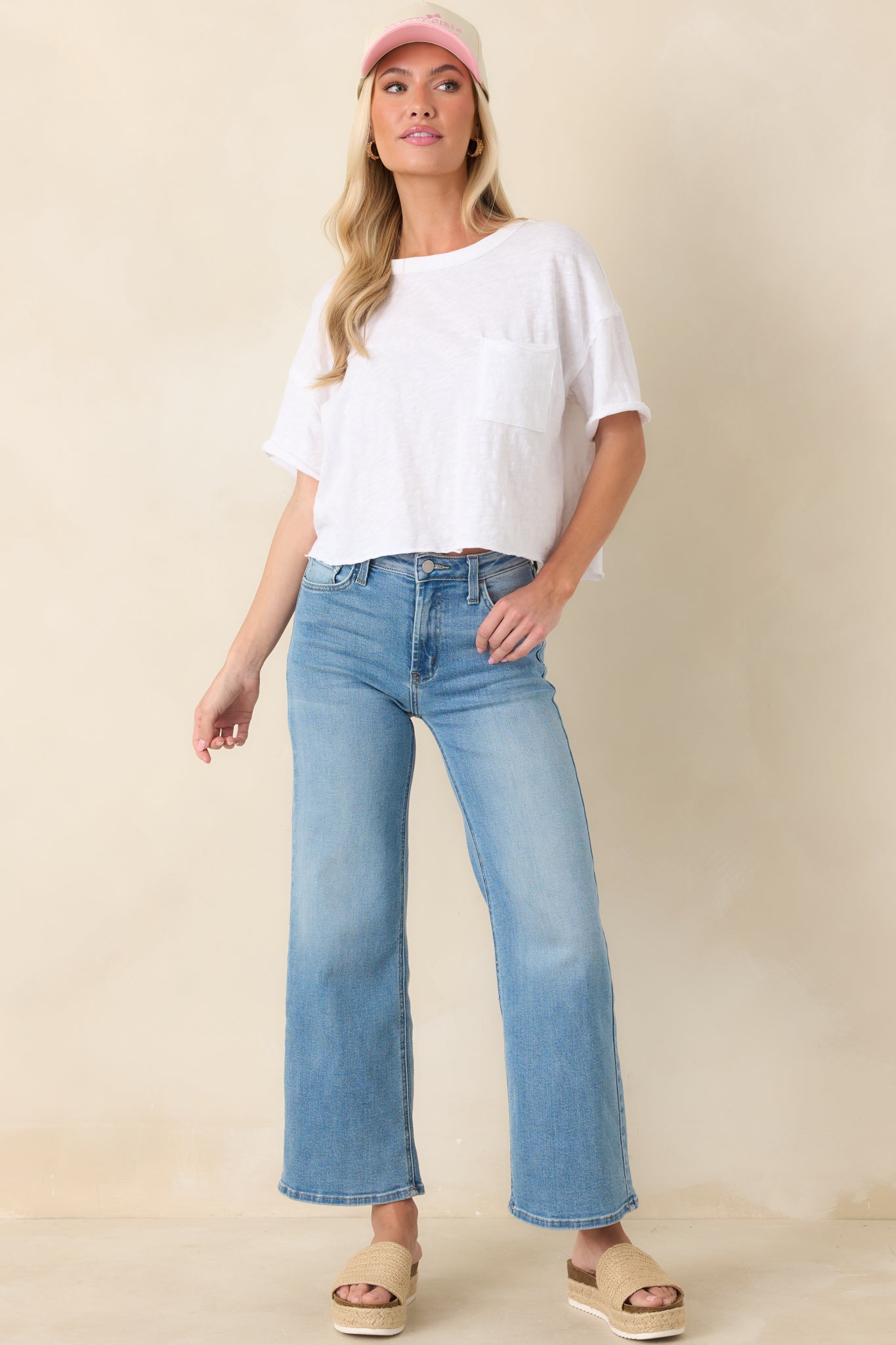 Front view of cropped wide-leg light blue jeans featuring belt loops, high-rise waist, and relaxed leg drape.