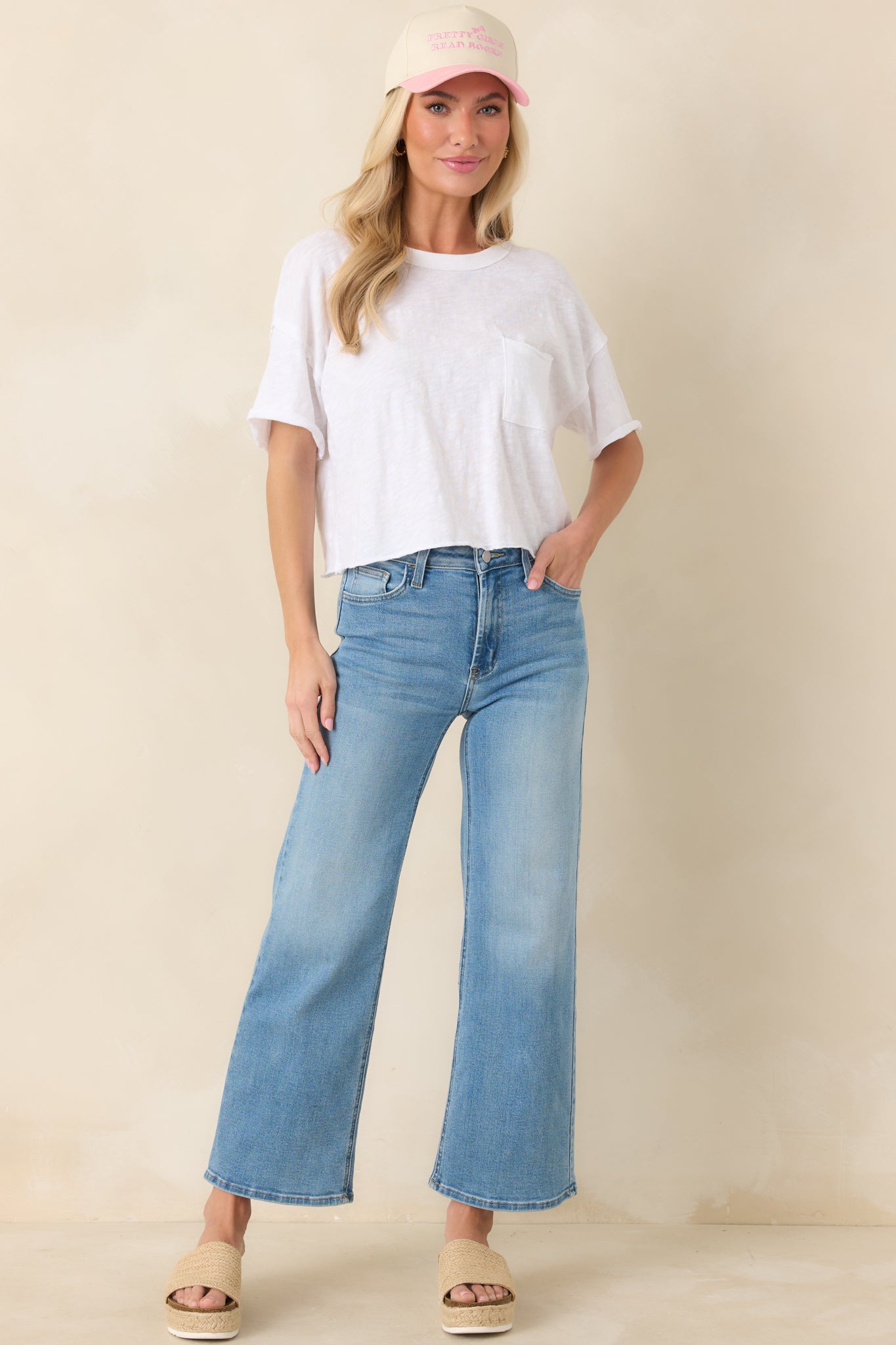 Wide-leg light wash jeans with structured high waist, clean cropped hem, and functional pocket detailing for casual styling.