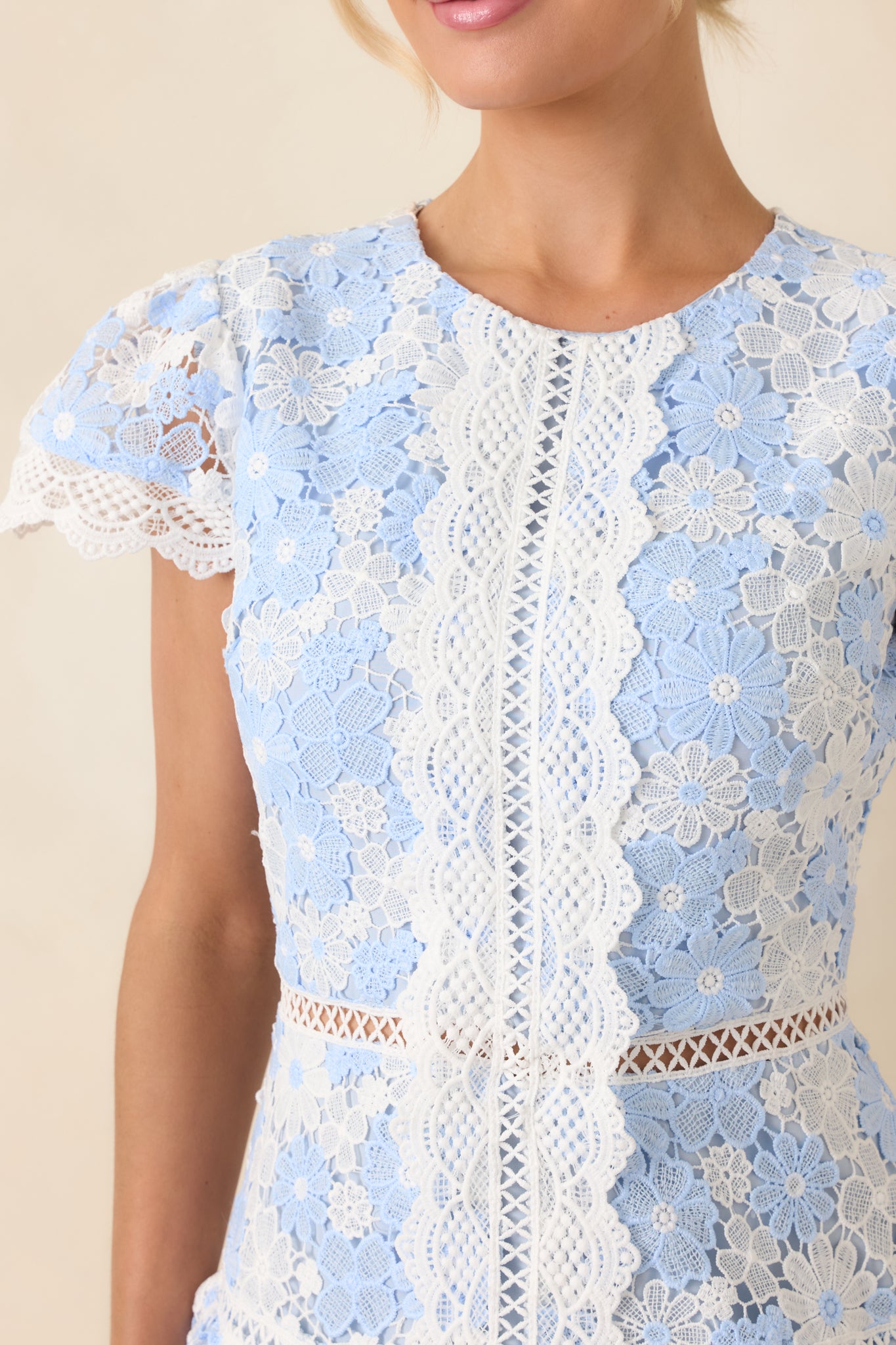 Close look at the ornate lace overlay, scalloped trim, and layered ruffle detailing that create soft dimension.