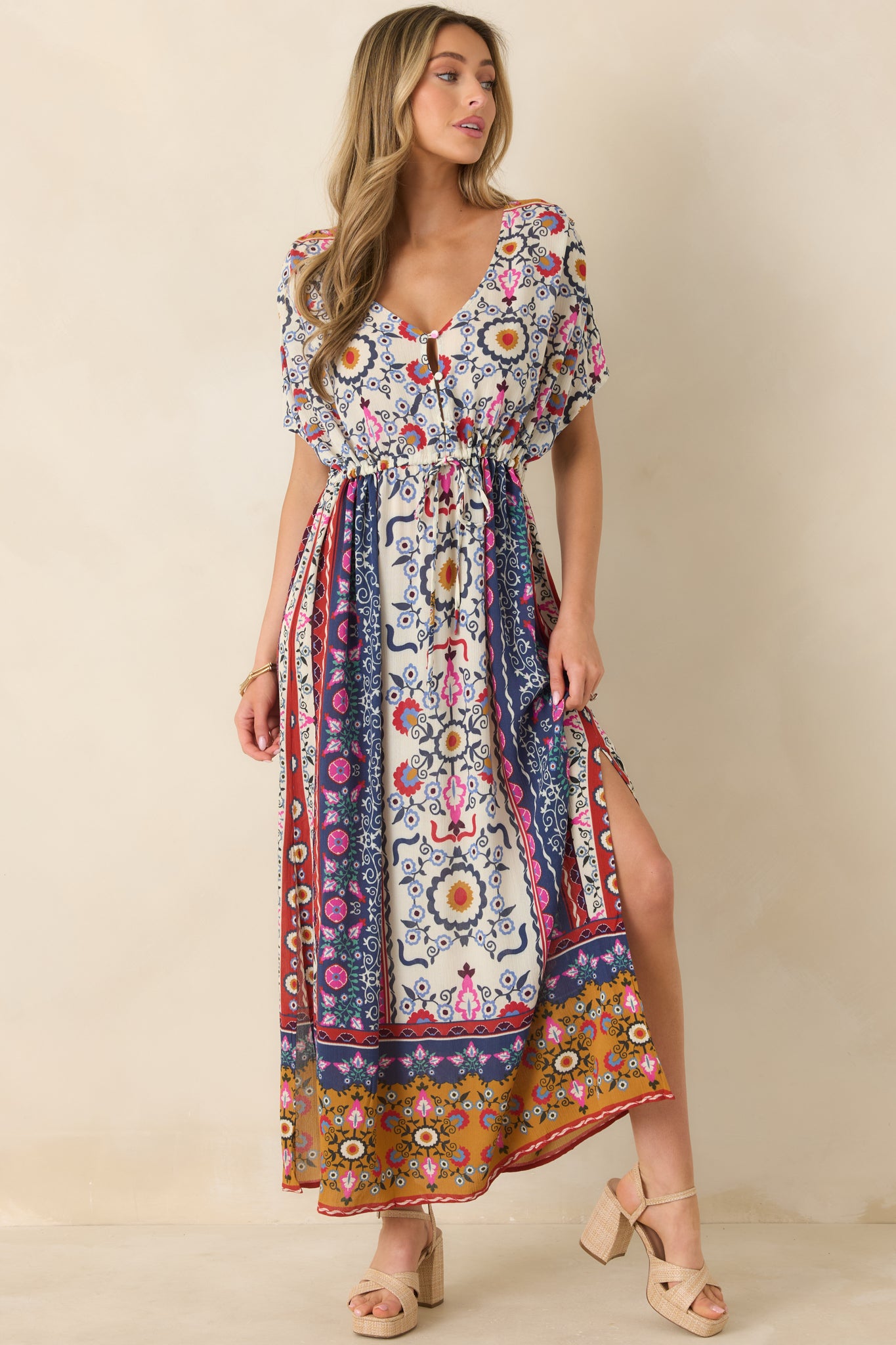 Woman wearing a colorful floral dress with a beige background