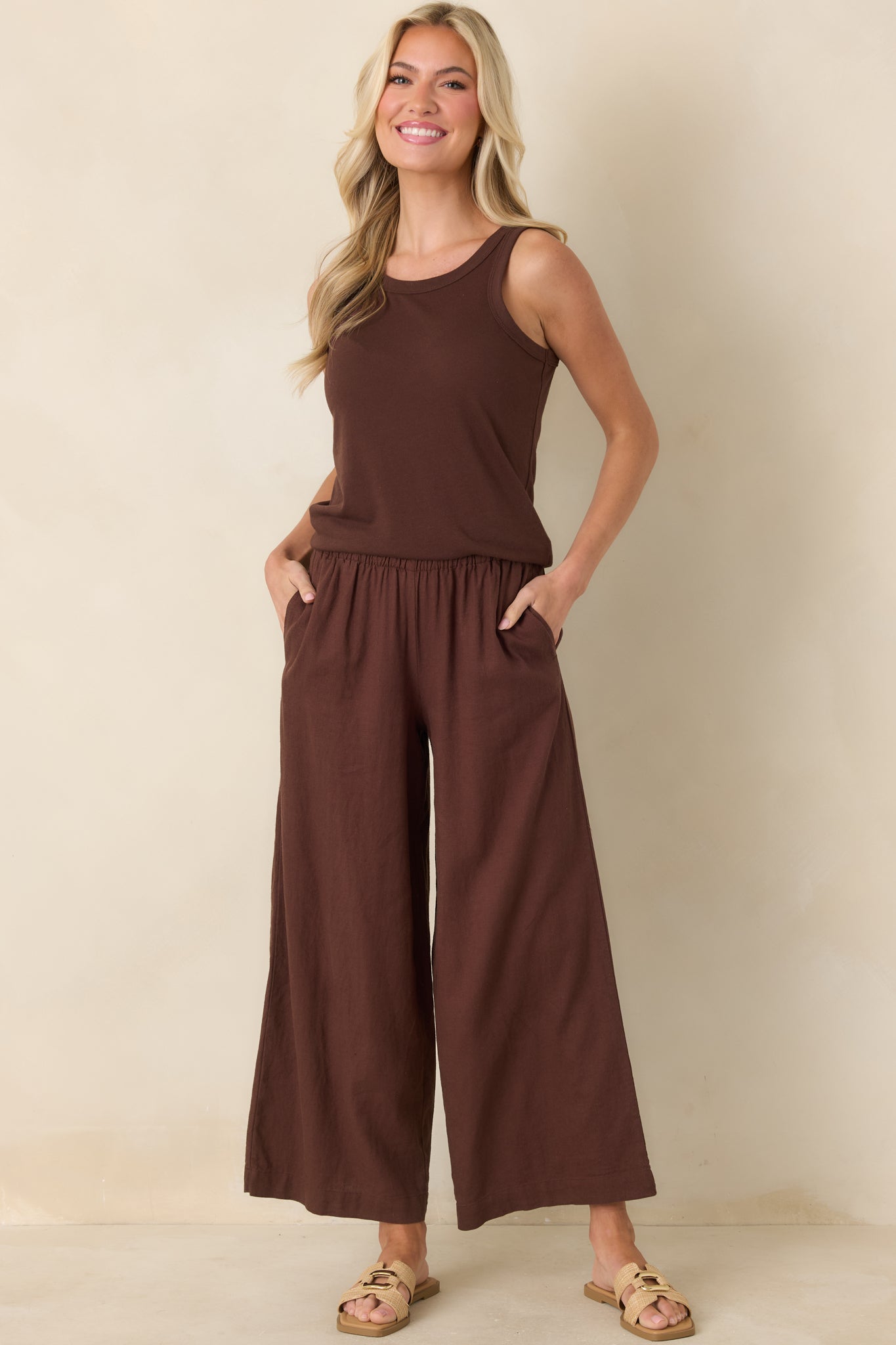 Brown sleeveless tank top with a round neckline and relaxed fit in a lightweight cotton blend.