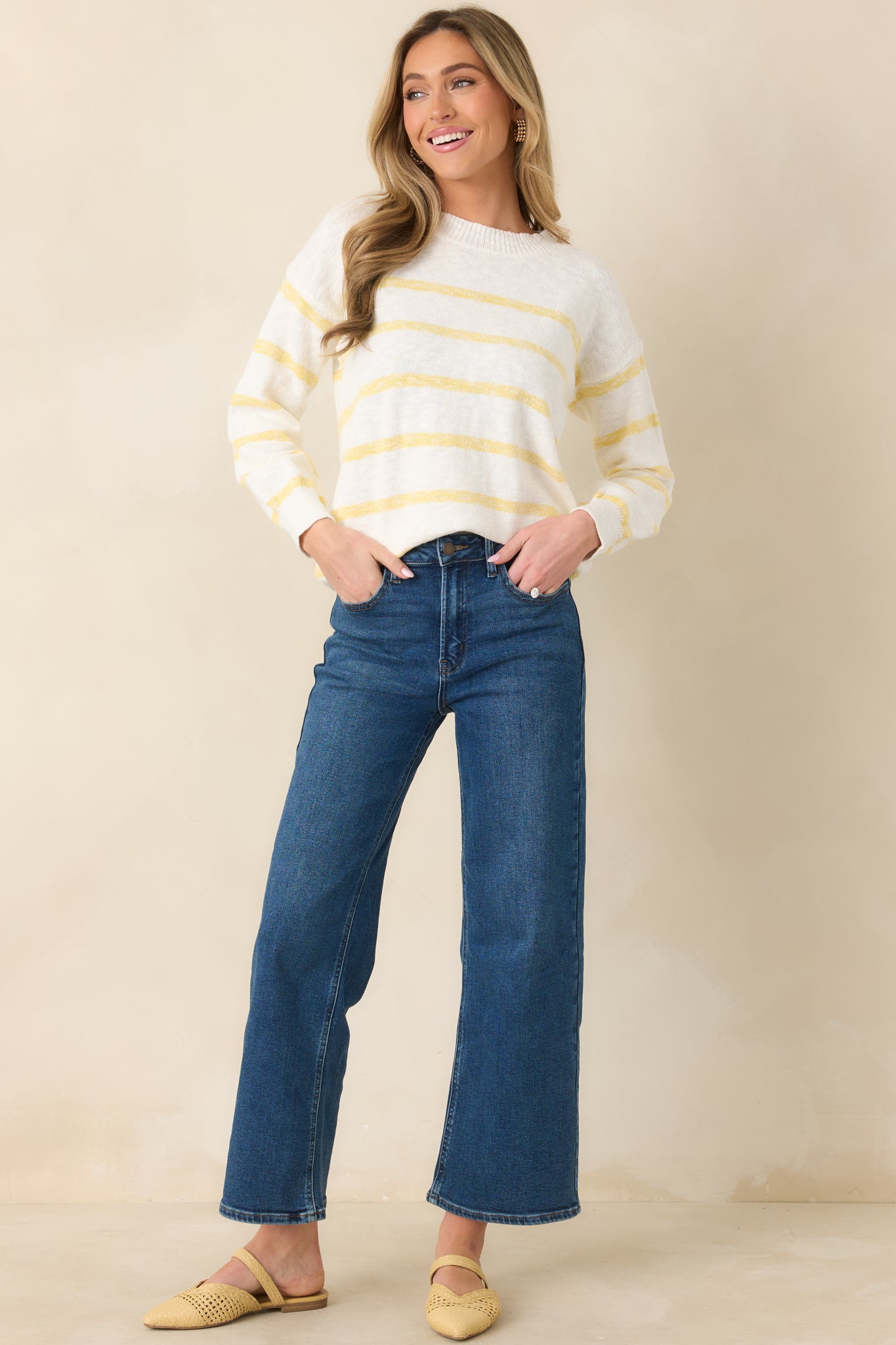 Lightweight ivory knit sweater with classic round neck and contrasting yellow stripe accents.