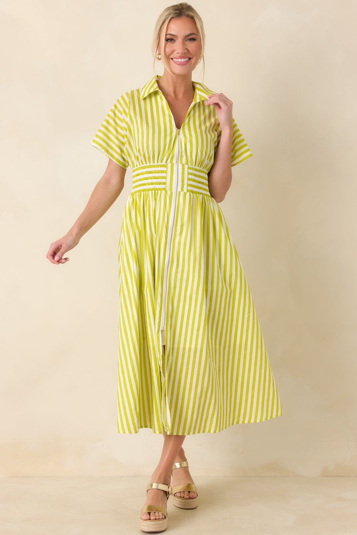 Front view of a tailored yet relaxed striped midi dress featuring functional pockets, short sleeves, and a lightweight woven cotton A-line silhouette.