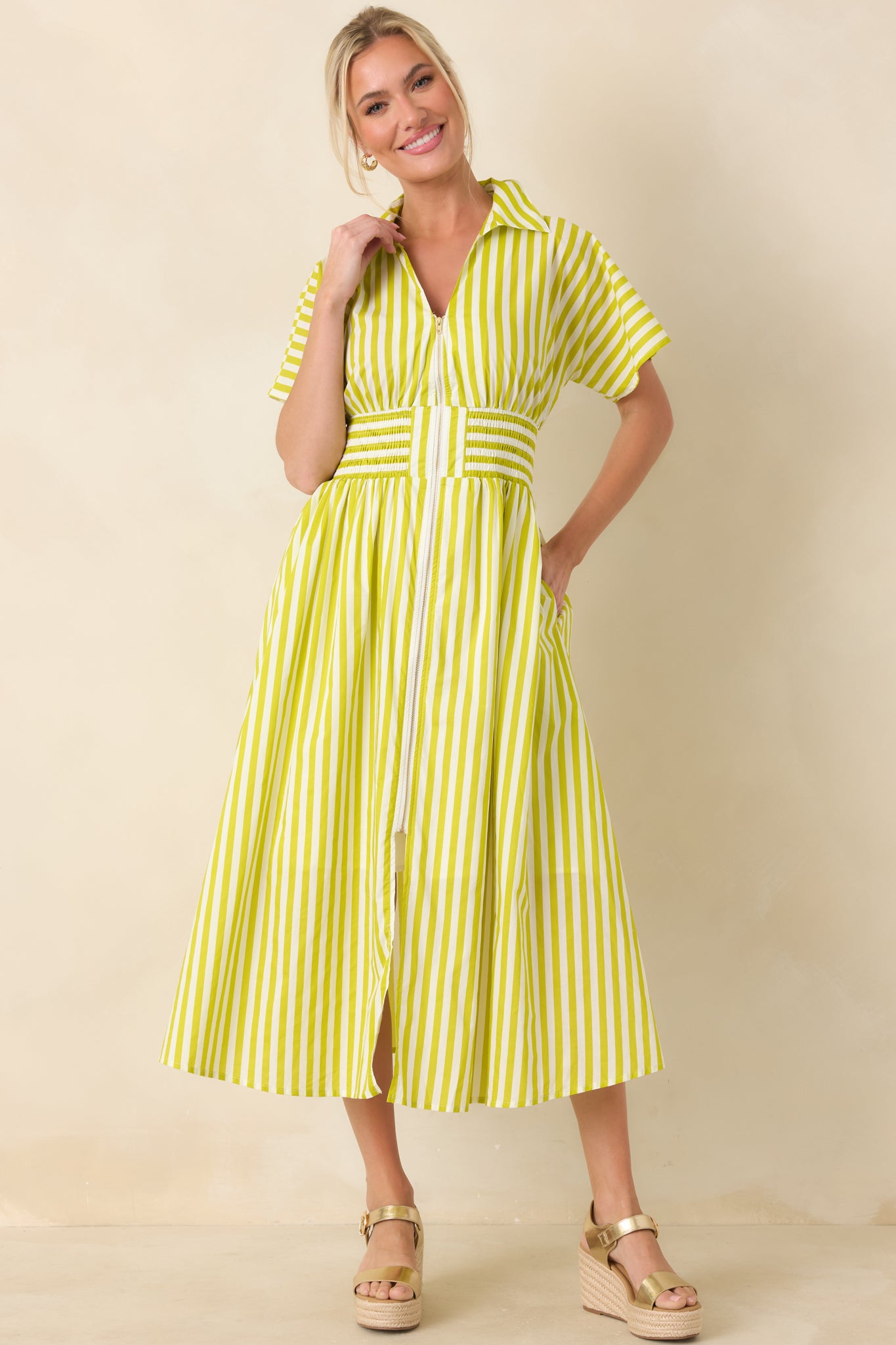Midi dress in green and white stripes with a zip-front closure, smocked waistband, and flowing A-line skirt for natural movement.
