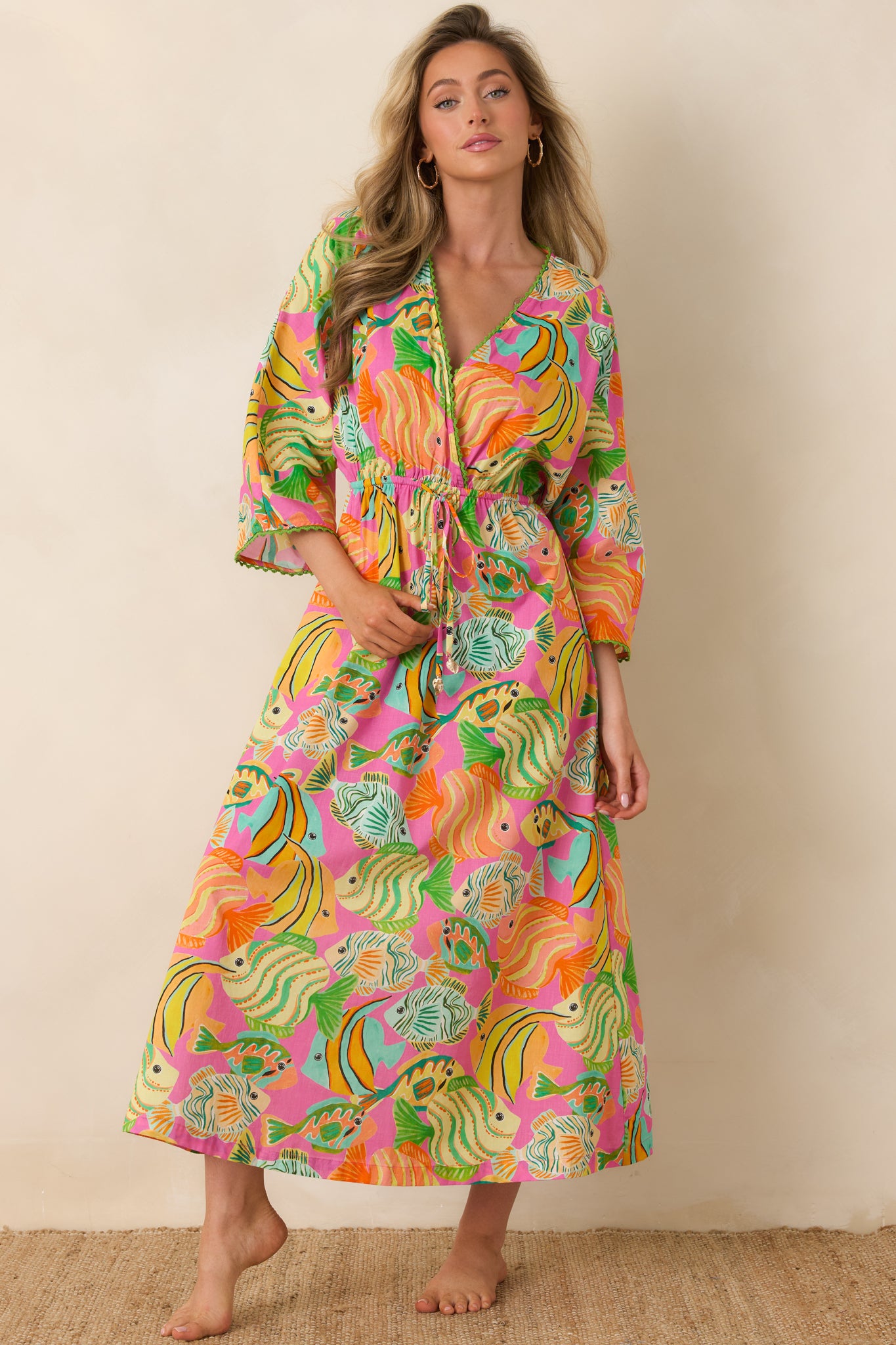 Vibrant ocean-print dress with relaxed shape, adjustable waist, and breezy elbow-length sleeves.