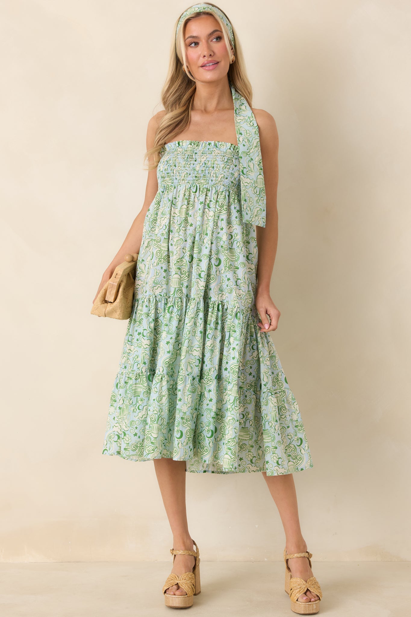 Blue and green midi dress with elastic smocked bodice, strapless neckline, and relaxed, knee-to-calf length skirt.
