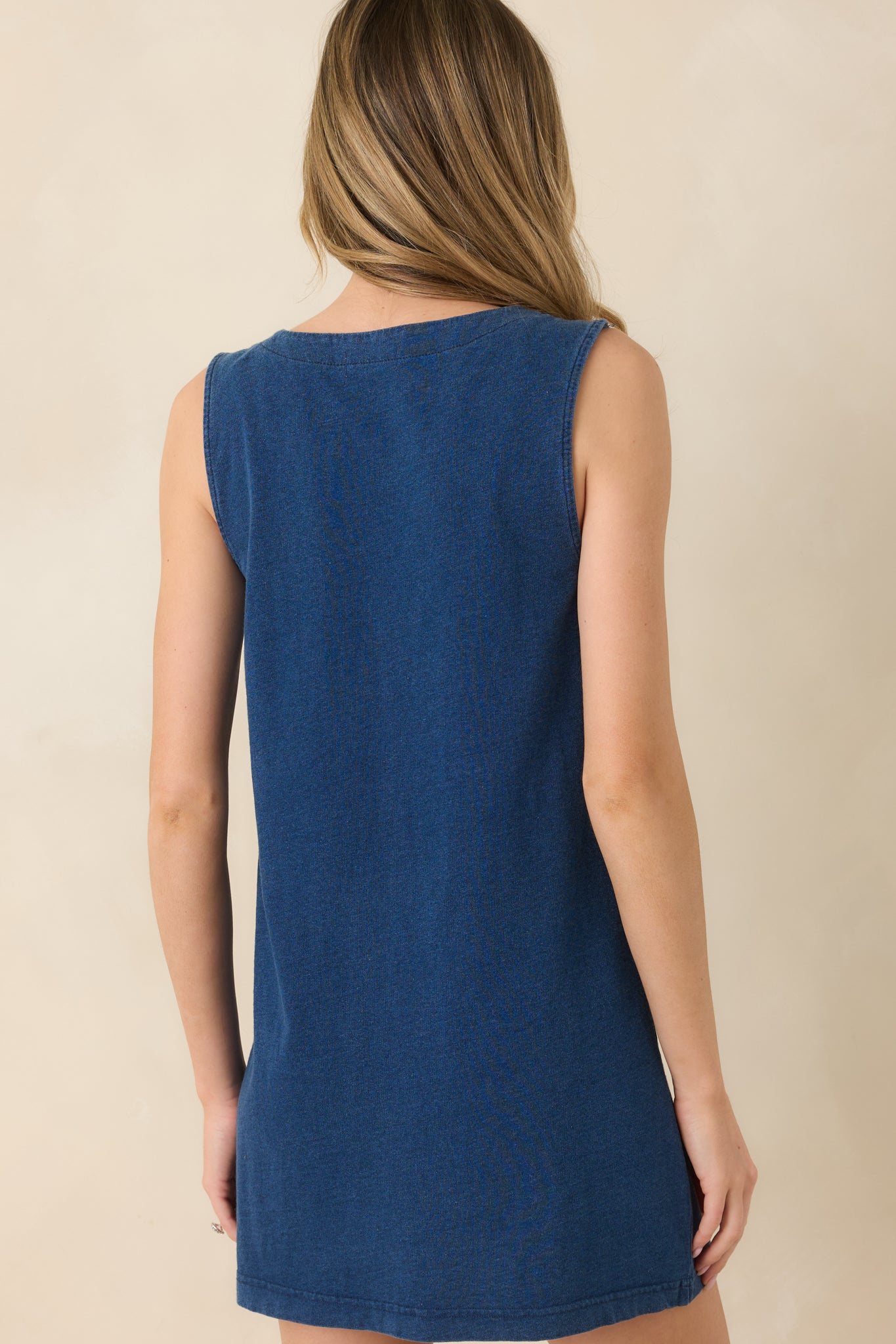 Rear view of dark wash sleeveless mini dress with relaxed, easy silhouette