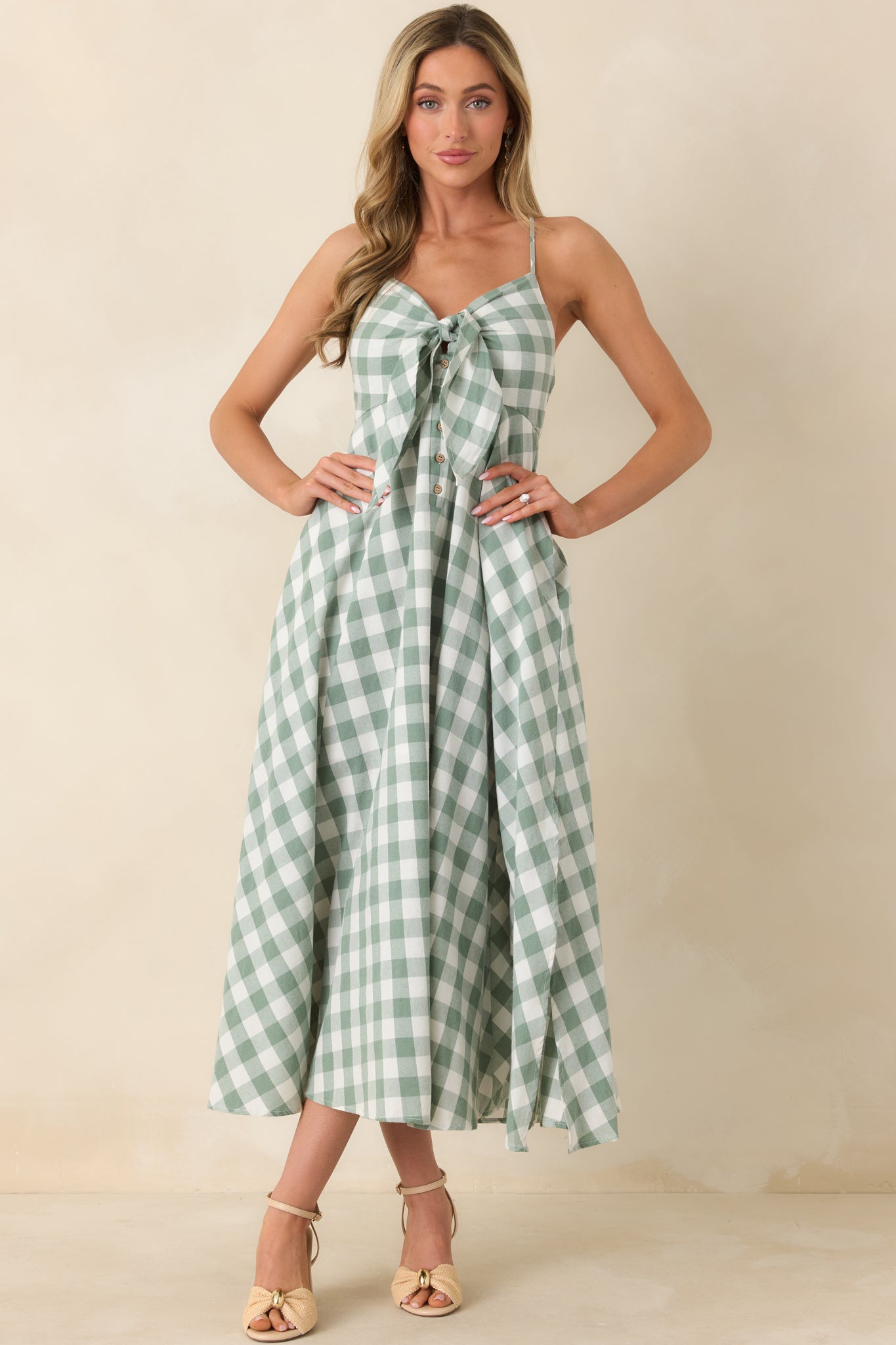 Romantic midi designed with a front tie at the neckline, vertical button detailing, and a fluid skirt that moves effortlessly with every step.