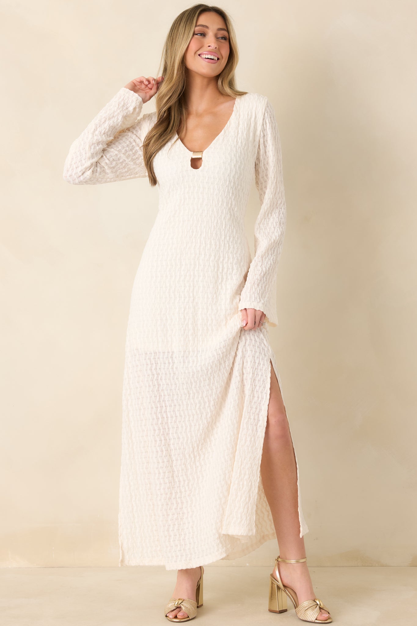 Sheer, textured maxi dress featuring long sleeves and soft, elegant drape.
