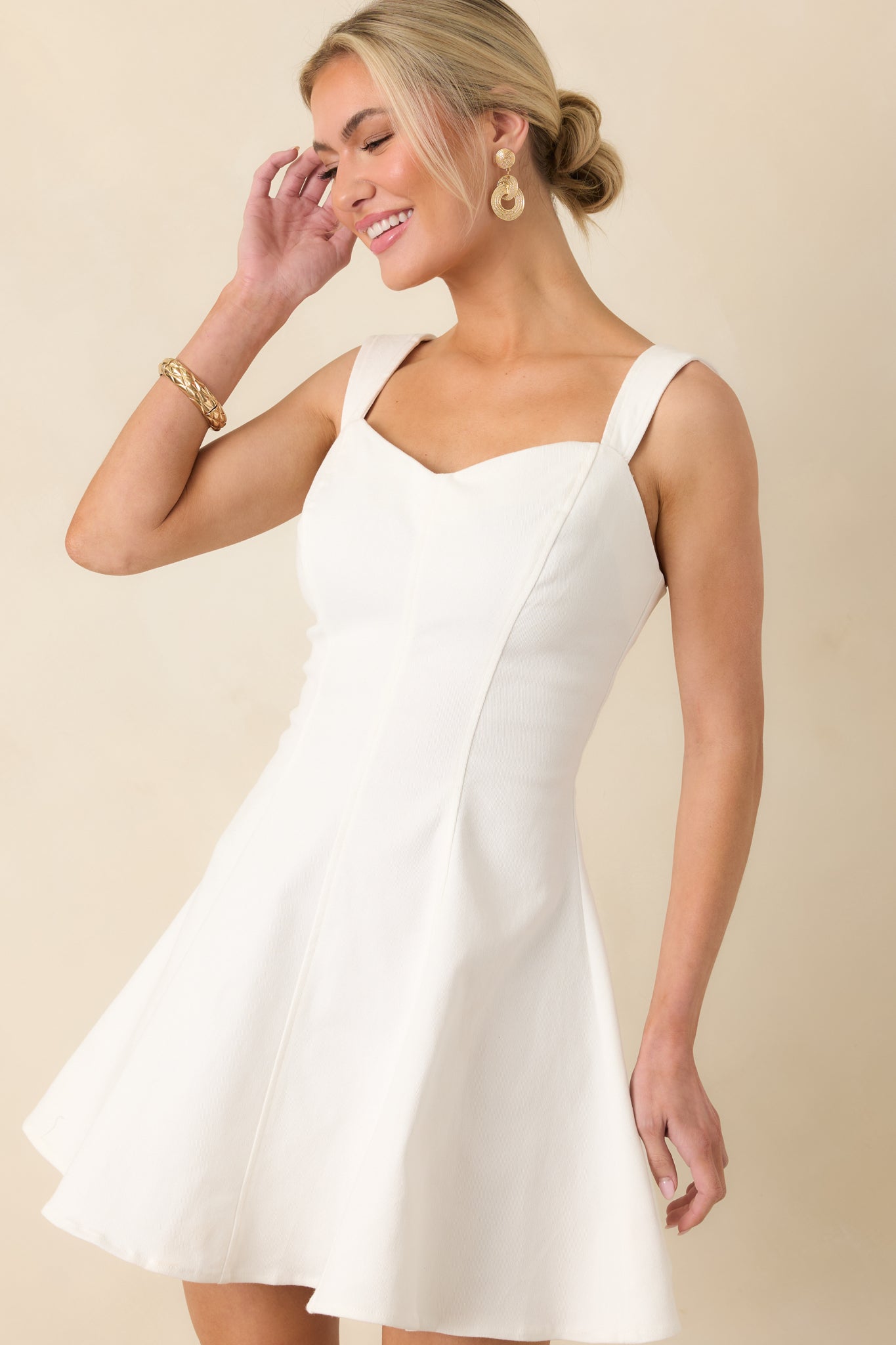 Cropped angled view focusing on the neckline and smooth fabric texture of the dress.