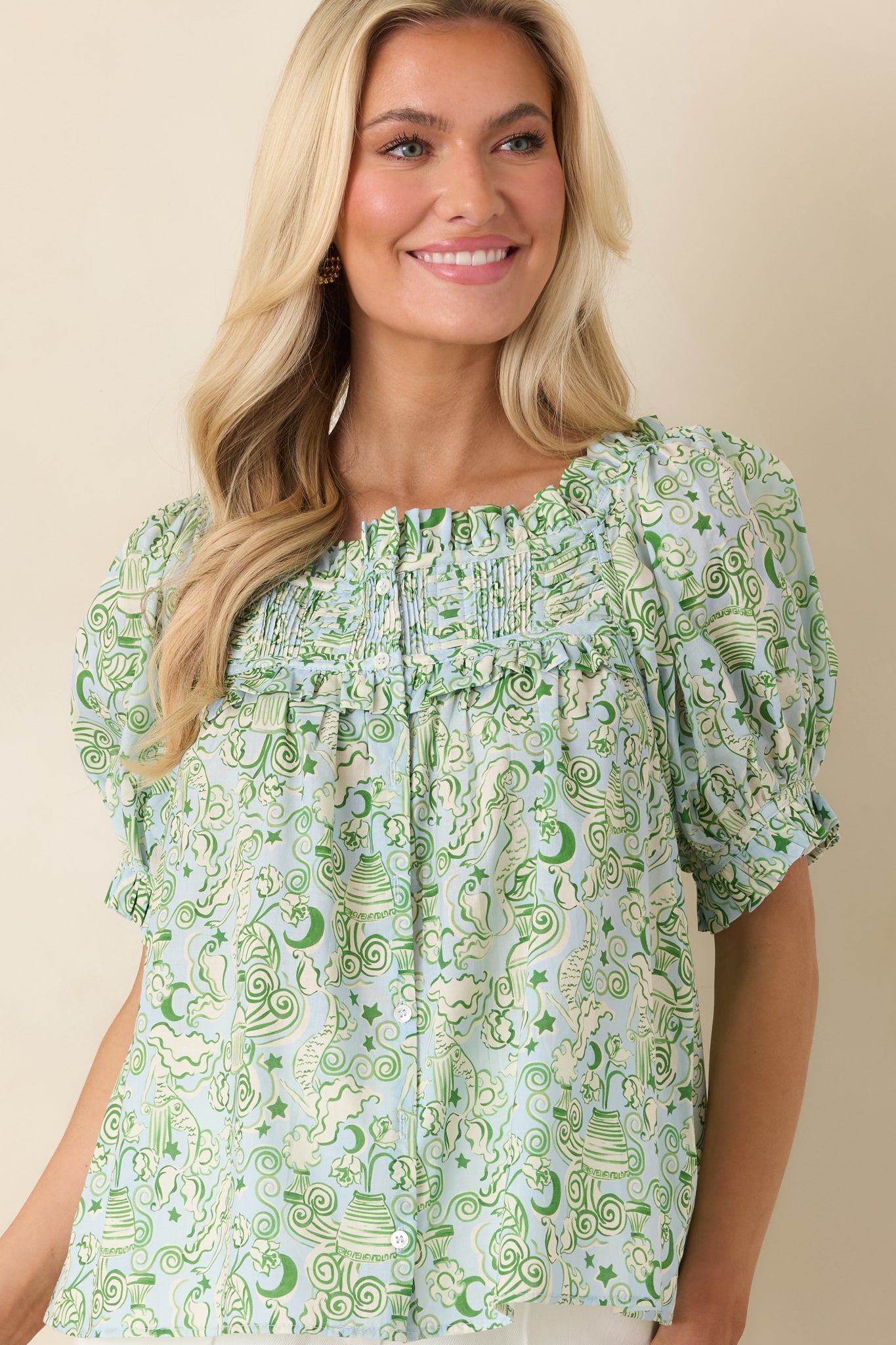 Pintuck detailing along the chest of blue and green blouse.