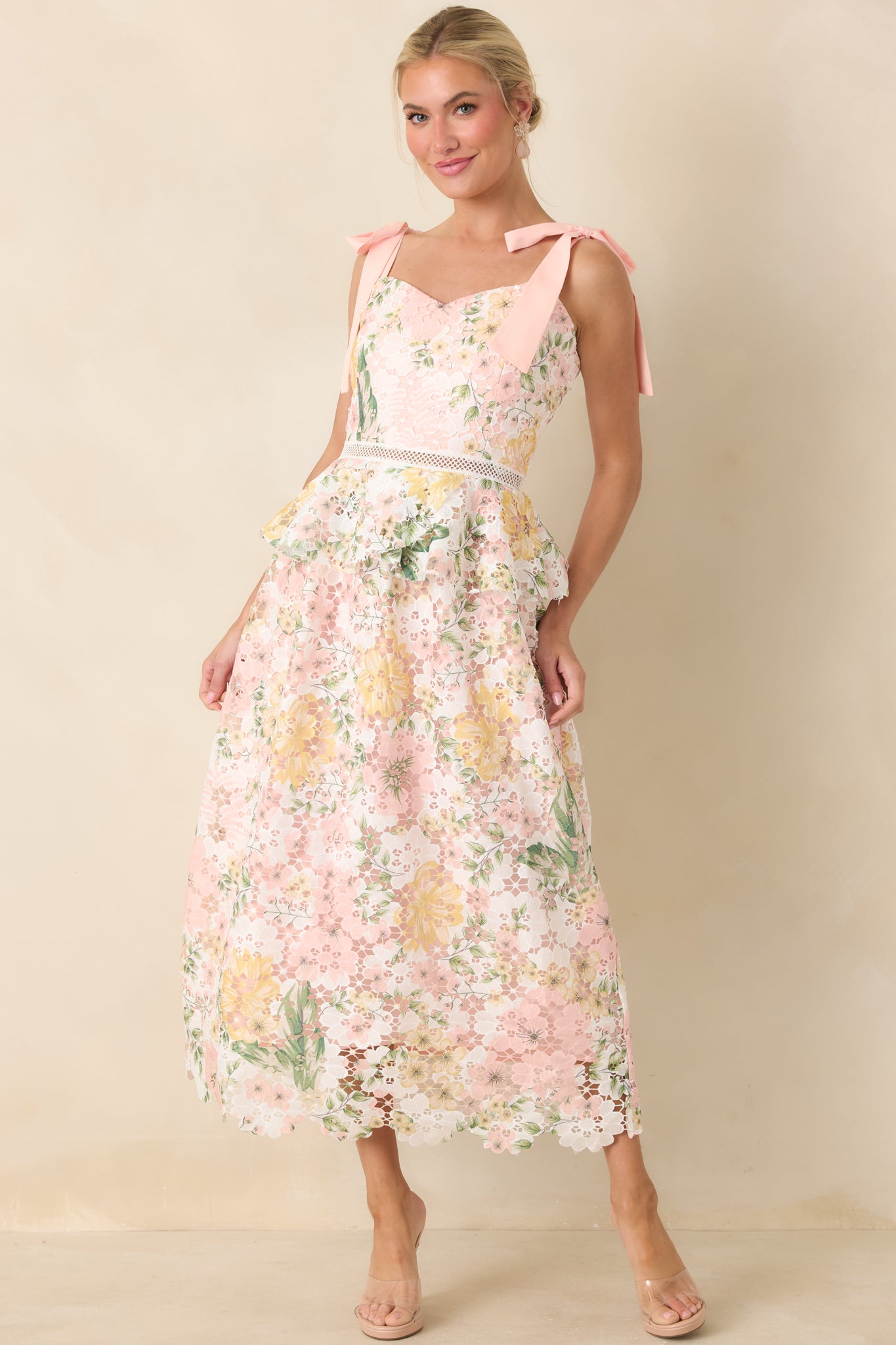 Peach floral lace midi dress with V-neckline, self-tie straps, and ruffle detailing at the waist.