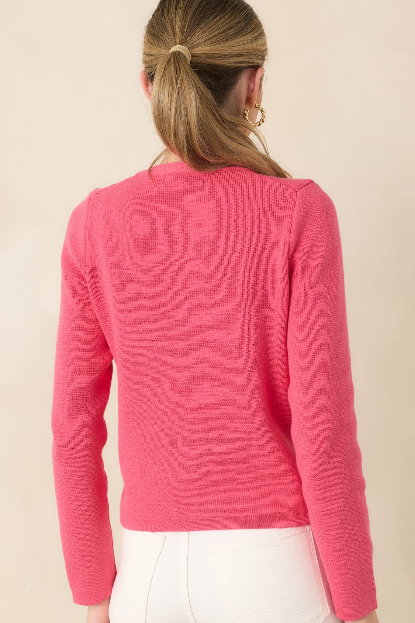 Rear view of the cotton cardigan featuring the softly textured knit and clean, classic silhouette.