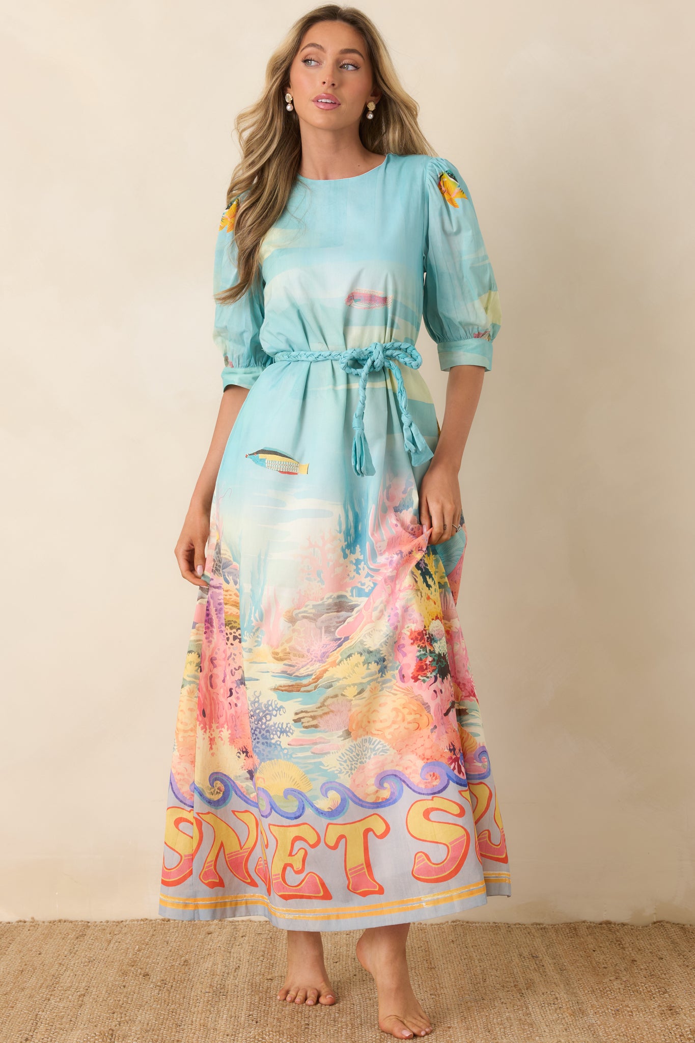 Maxi dress with tropical sea life print, coral tones, and ocean wave motifs.